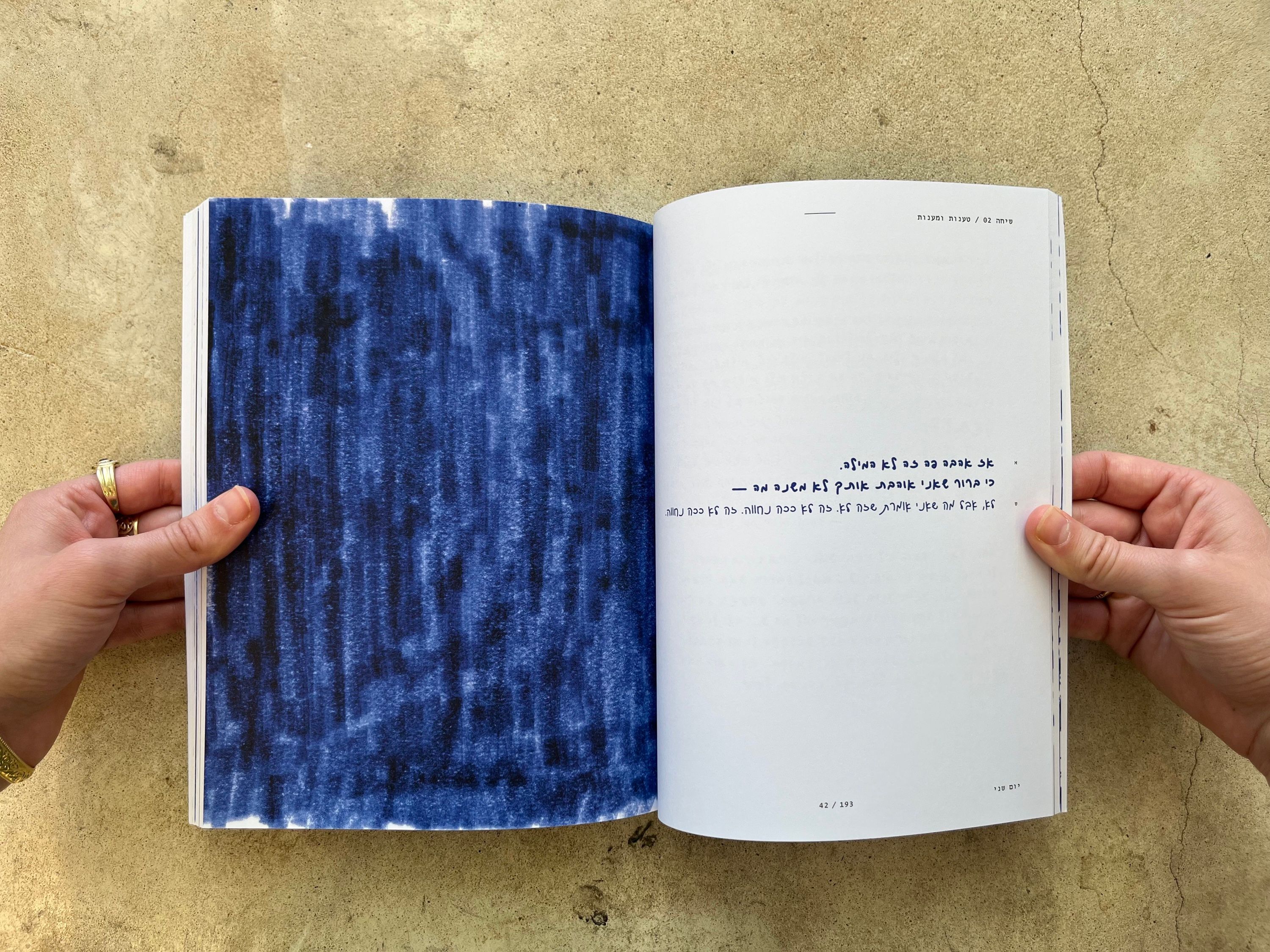 A page filled with blue marker strokes facing a page of text